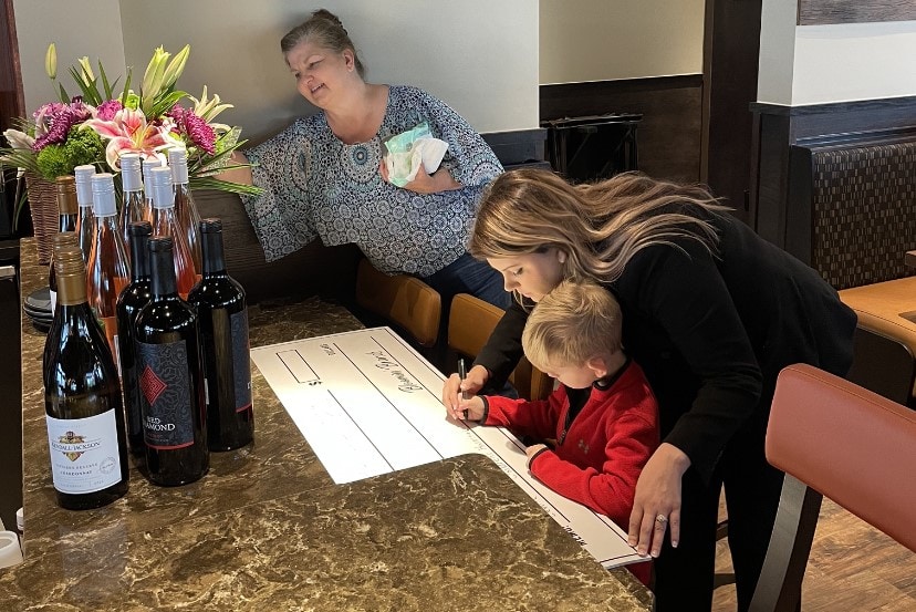 Levine Children's patient signs check to LCH